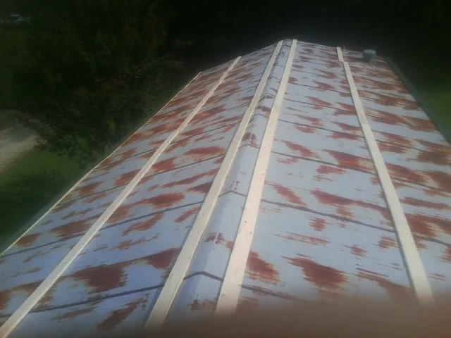 Rusted metal roof panels with new wood purlins before replacement — Storm Damage Roof Repair in Mount Tabor by Roofing Brothers