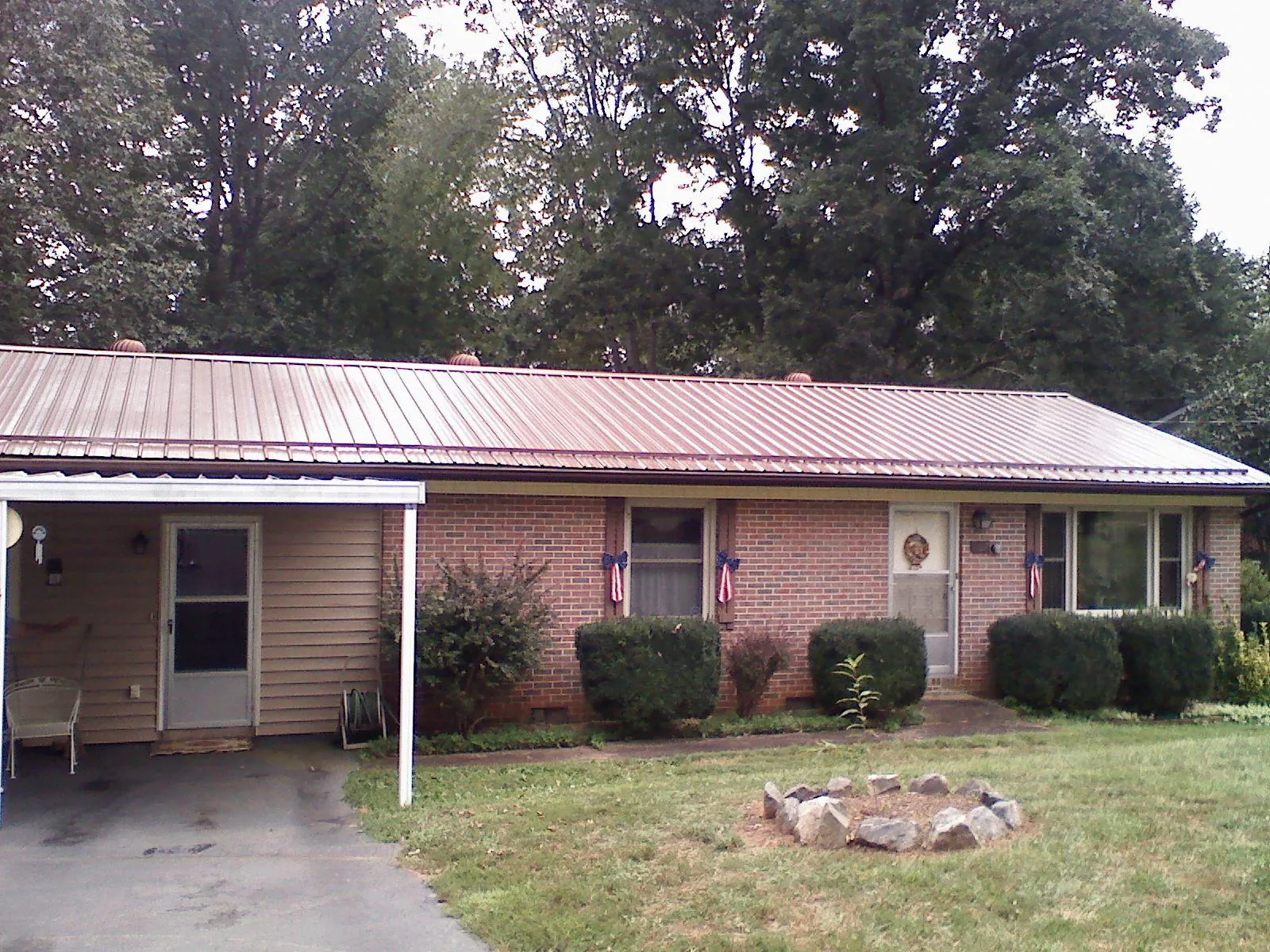 Bronze metal roof and carport on a brick ranch home — Roof Repair work by our crew in Mount Tabor