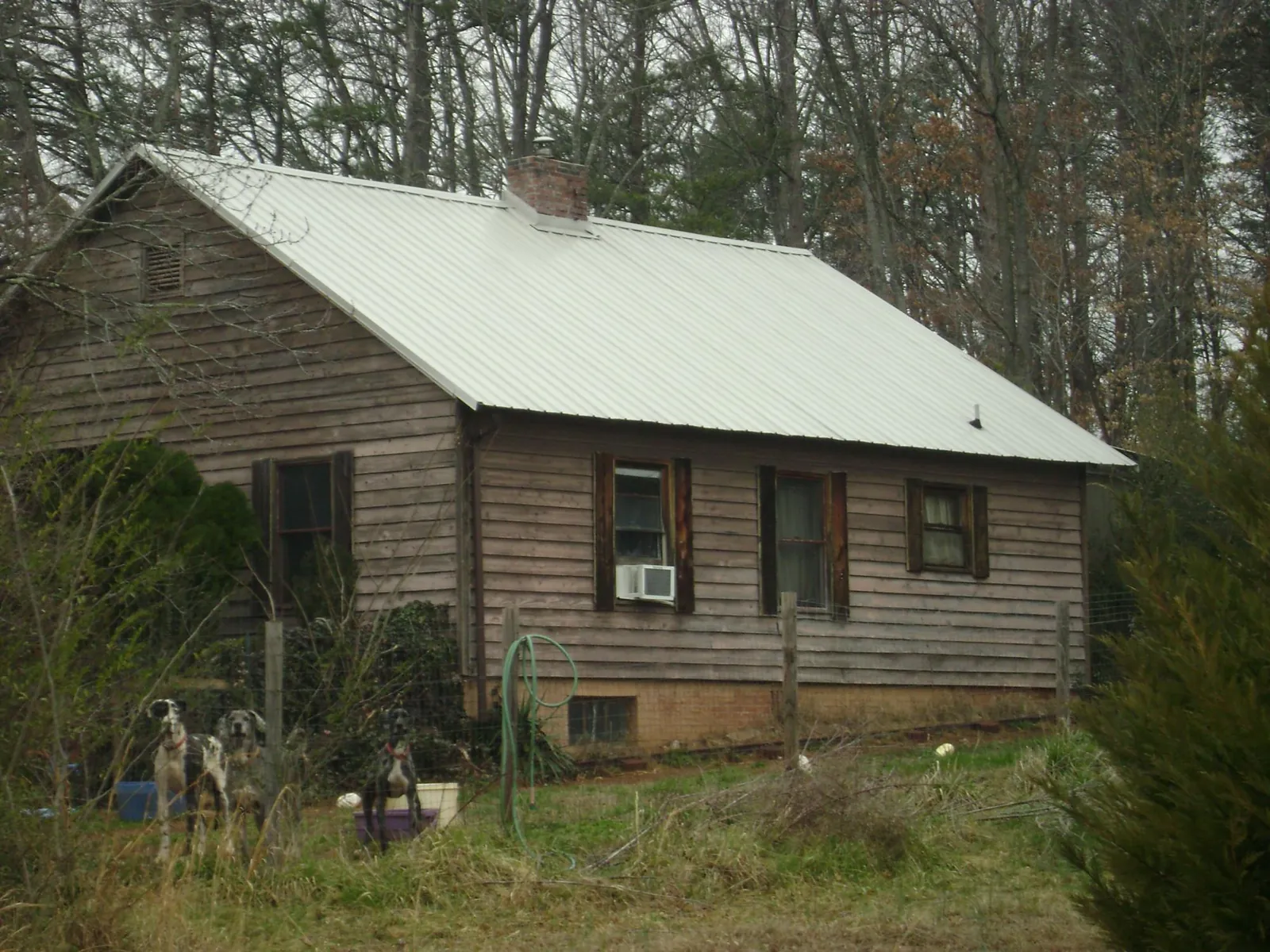 White metal roof on an old wood sided farmhouse, from a Metal Roof Installation job in Mount Tabor